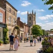 Historic buildings, a church and visitors in Thirsk town centre